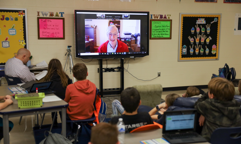 Classroom of students looking at zoom monitor Classroom of students looking at zoom monitor